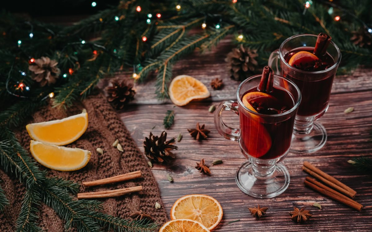 Two glasses of mulled wine with spices and orange slices