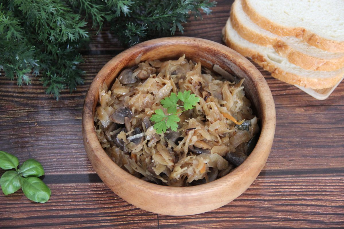 Sauerkraut braised with wild mushrooms in a wooden bowl
