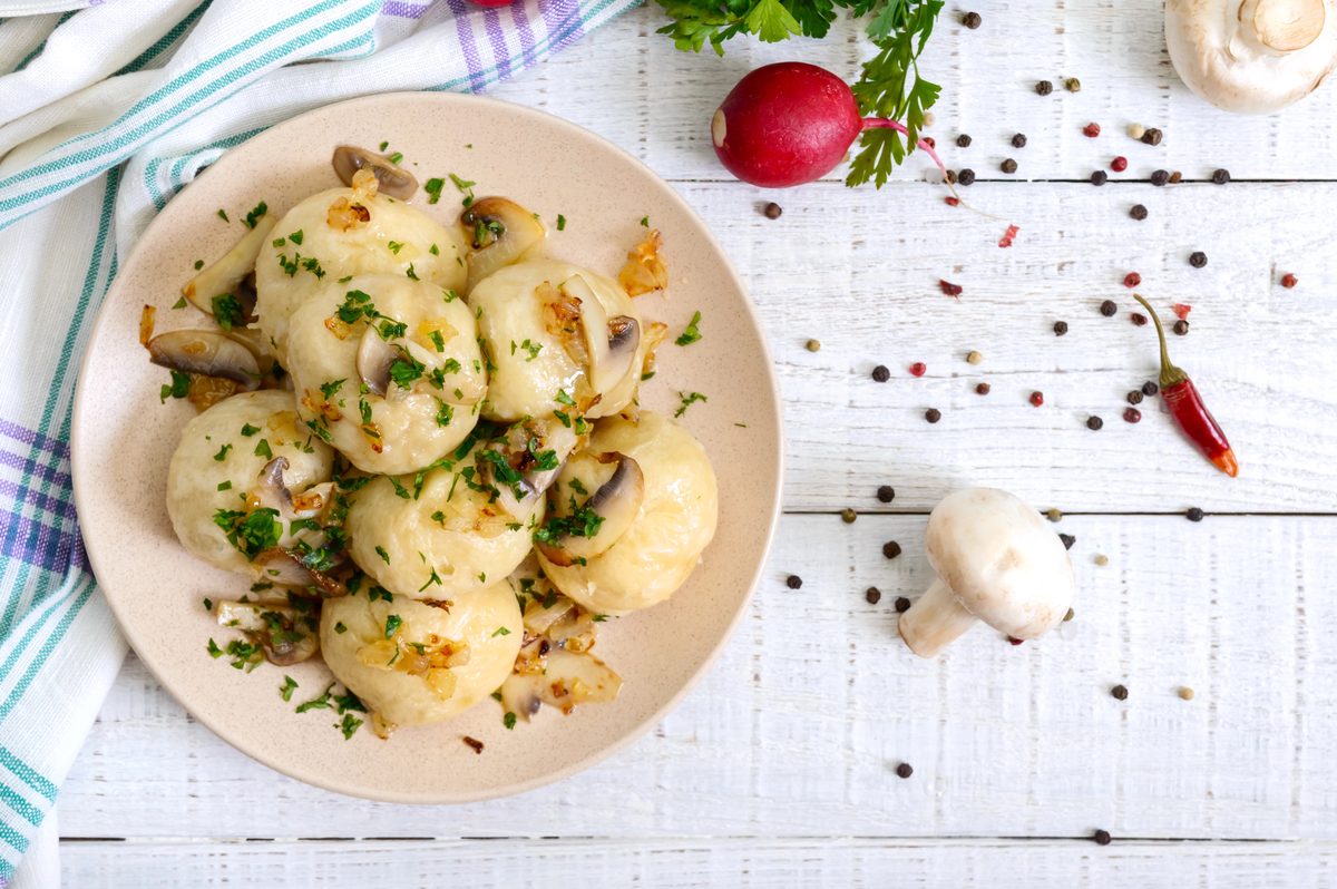 Varenyky dumplings in a bowl with mushrooms