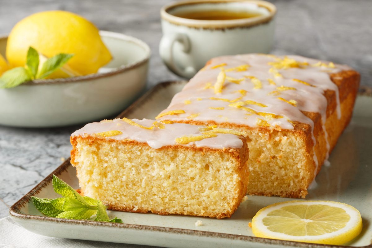 Glazed lemon cake with lemon zest and lemon slices