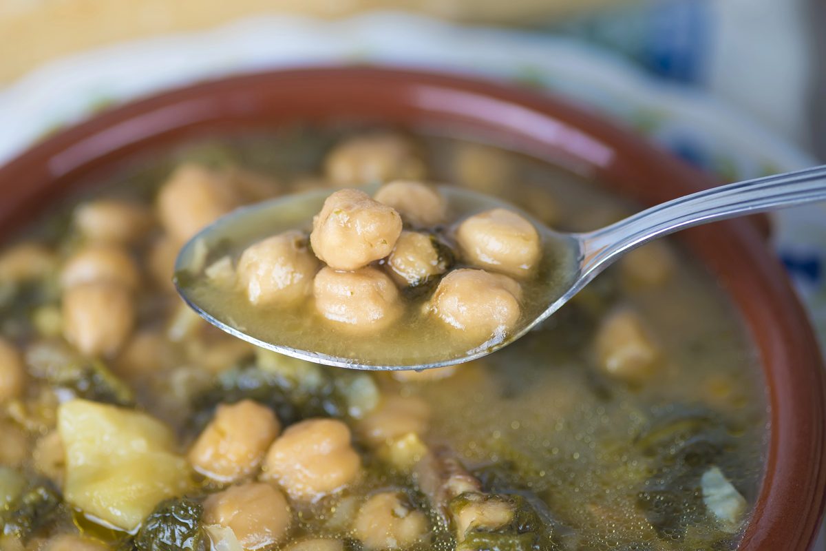 Chickpea and spinach soup in a clay bowl
