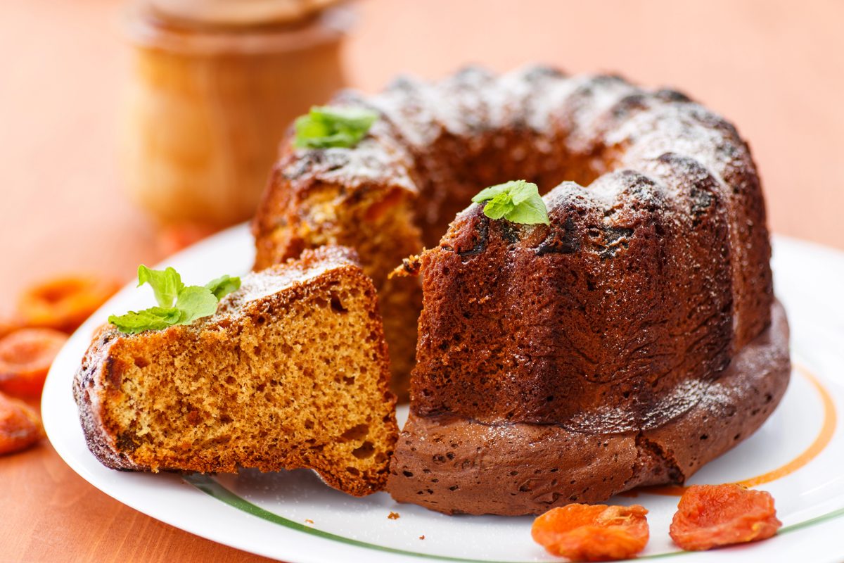 Dark honey bundt cake with a slice cut
