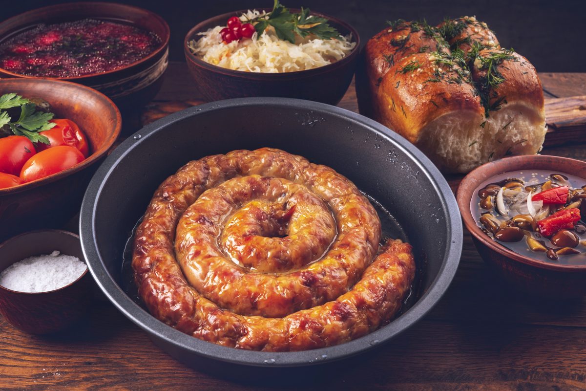Coiled homemade Ukrainian sausage in a pan
