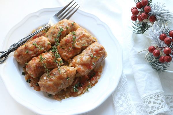 Sarma cabbage rolls in tomato sauce on a festive plate