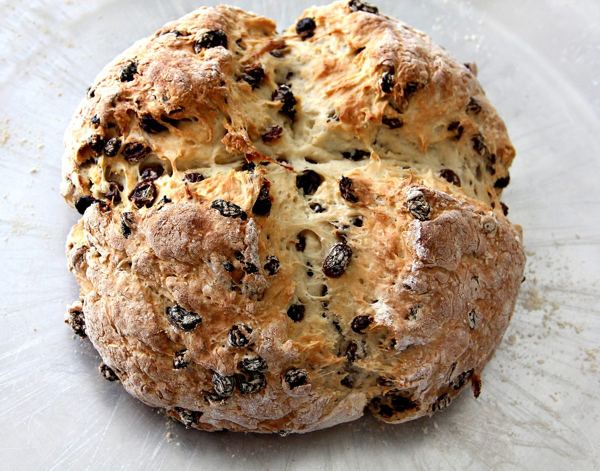 Round loaf of Irish soda bread with raisins and a cross scored on top