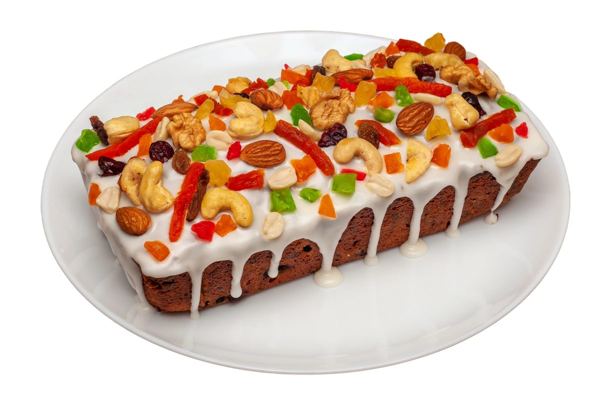 Loaf-shaped Irish Christmas fruit cake topped with nuts and candied fruit