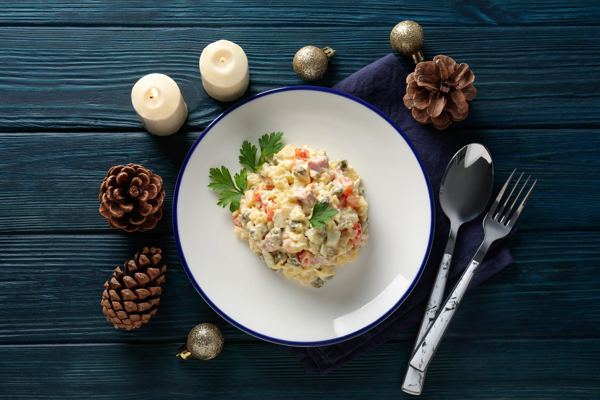 Russian salad of potatoes, peas and mayonnaise on a festive table