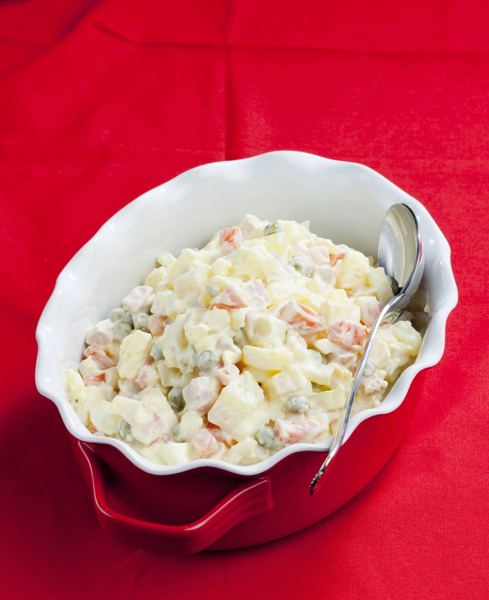 Slovak potato salad with vegetables and mayonnaise in a red bowl