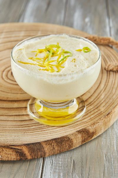 Lemon mousse in a glass dessert cup topped with lemon zest