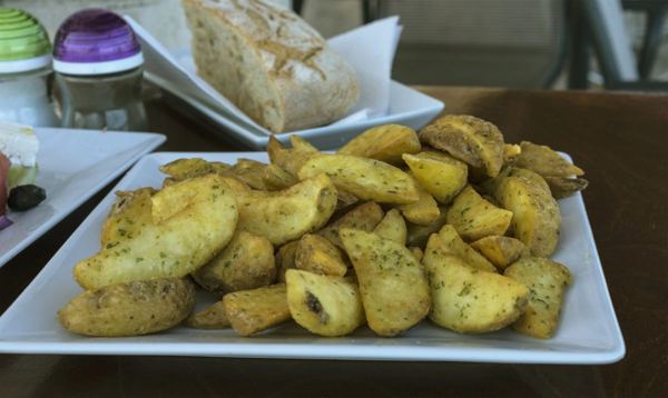 Greek roast potatoes with herbs on a serving dish