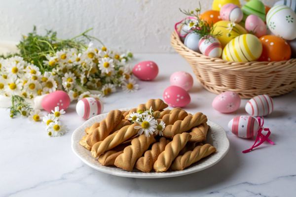 Twisted koulourakia butter cookies with Easter eggs and daisies