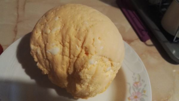 Sárgatúró, a round sweet Hungarian Easter egg cheese, on a plate