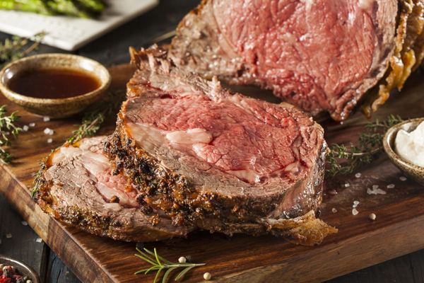 Sliced roast beef loin on a wooden board
