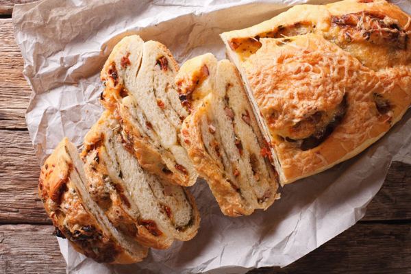 Sliced bread filled with cured meats