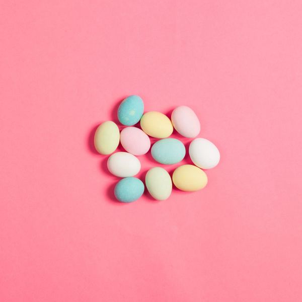 Pastel sugared Easter almonds on a pink background