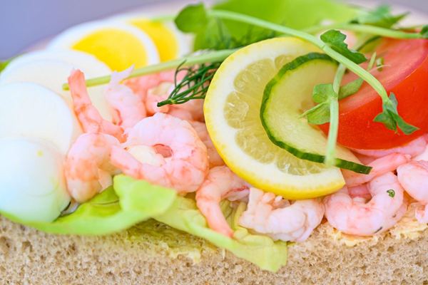 Open-faced shrimp sandwich with egg and lemon