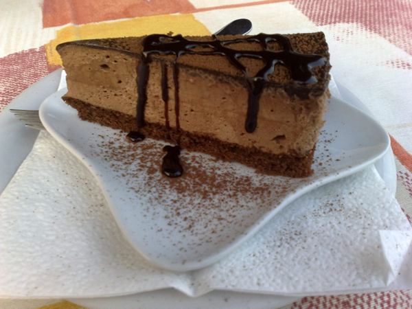 Slice of Rigó Jancsi chocolate mousse cake with chocolate drizzle