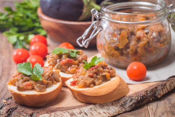 Eggplant caviar in a glass jar and on toasted bread