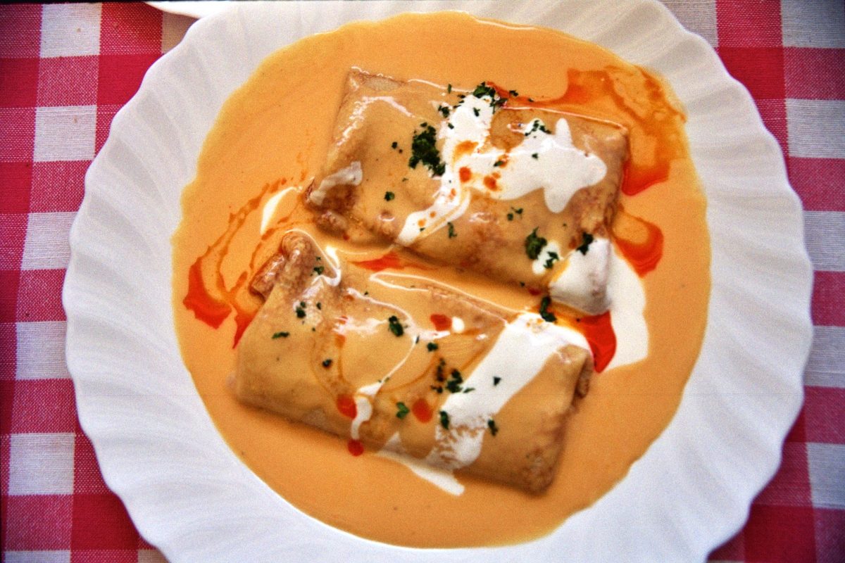 Meat-filled crepes in paprika cream sauce with sour cream
